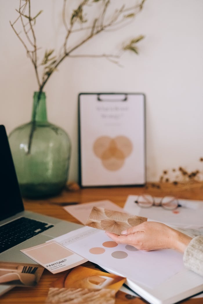 A creative workspace with color swatches on a desk, perfect for design inspiration and artistic projects.